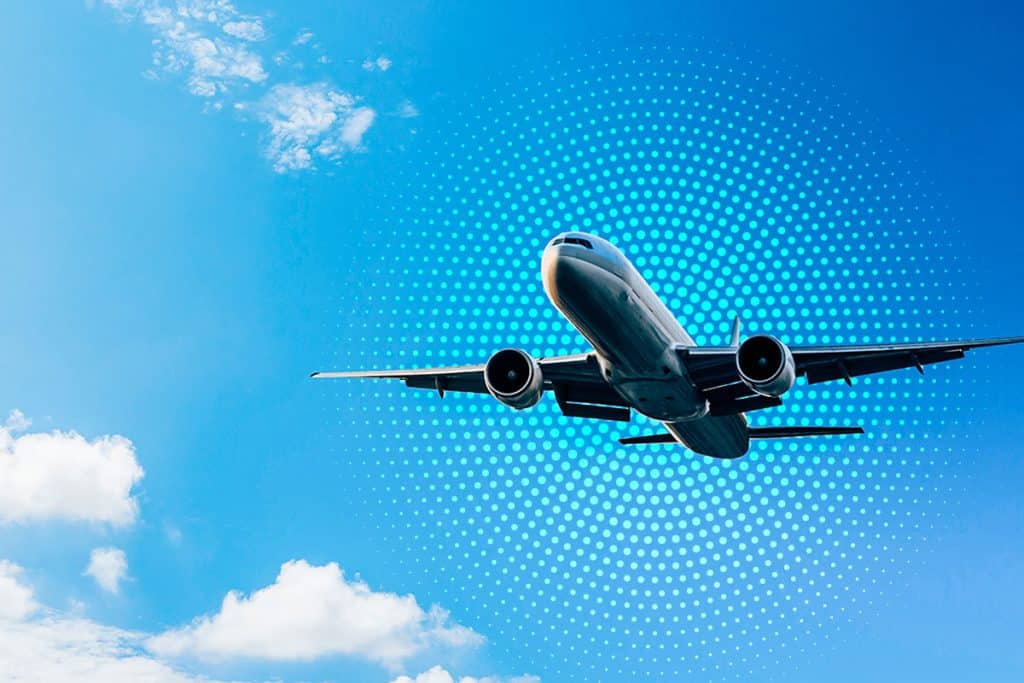 Commercial airplane in sky with circling digital dot design to illustrate inflight connectivity.
