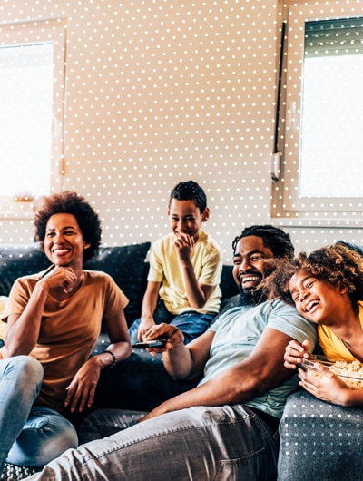 family on sofa laughing