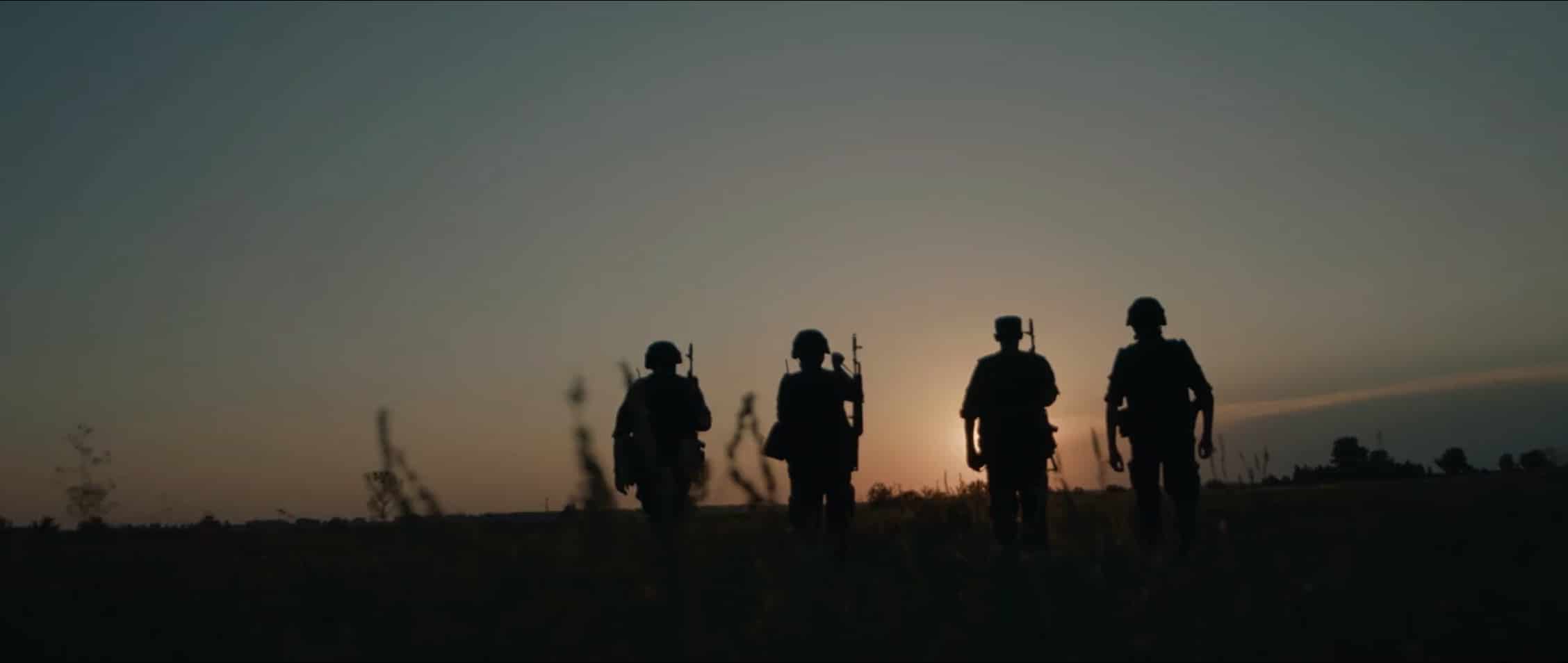 a group of soldiers walking in a field
