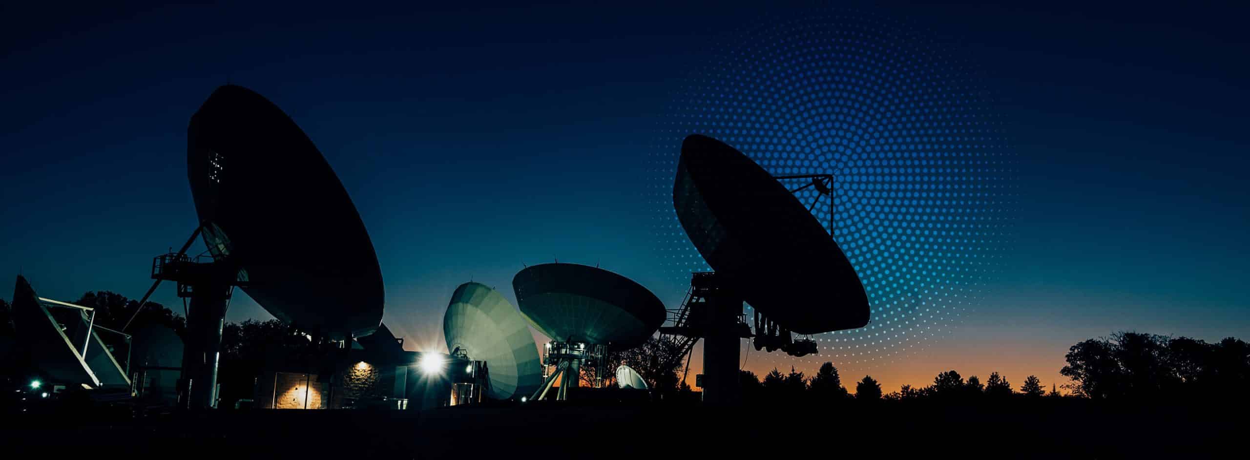 multiple satellite dishes in a night sky