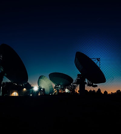 multiple satellite dishes in a night sky