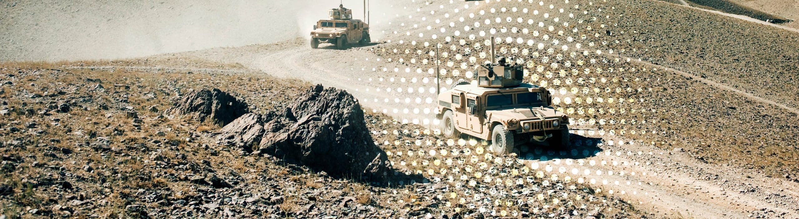 military vehicles driving on mountain roads
