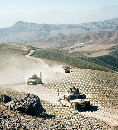 military vehicles driving on mountain roads