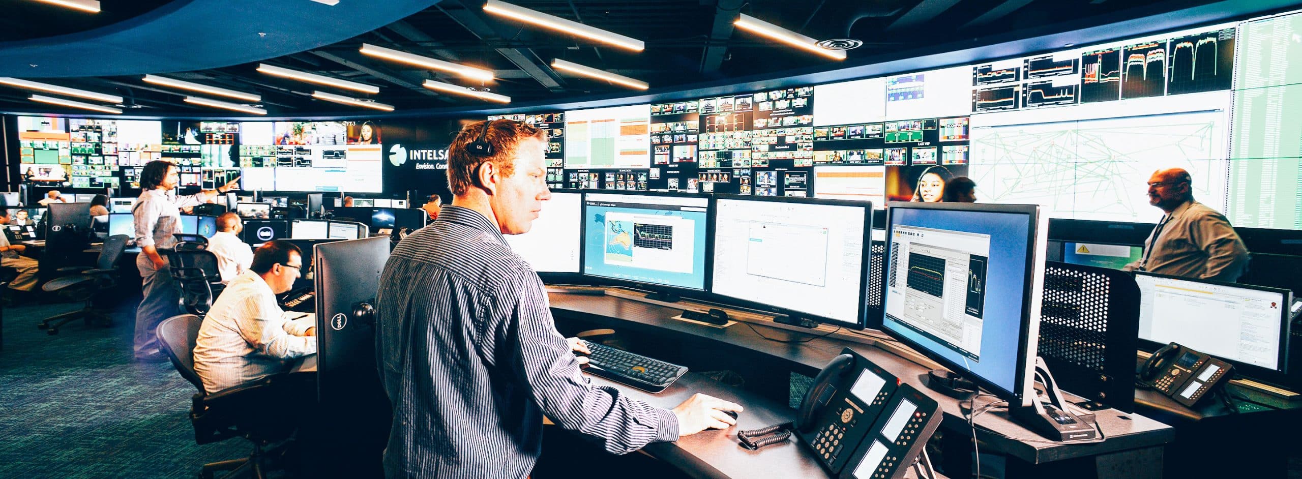 multiple people working in a satellite flight operations center