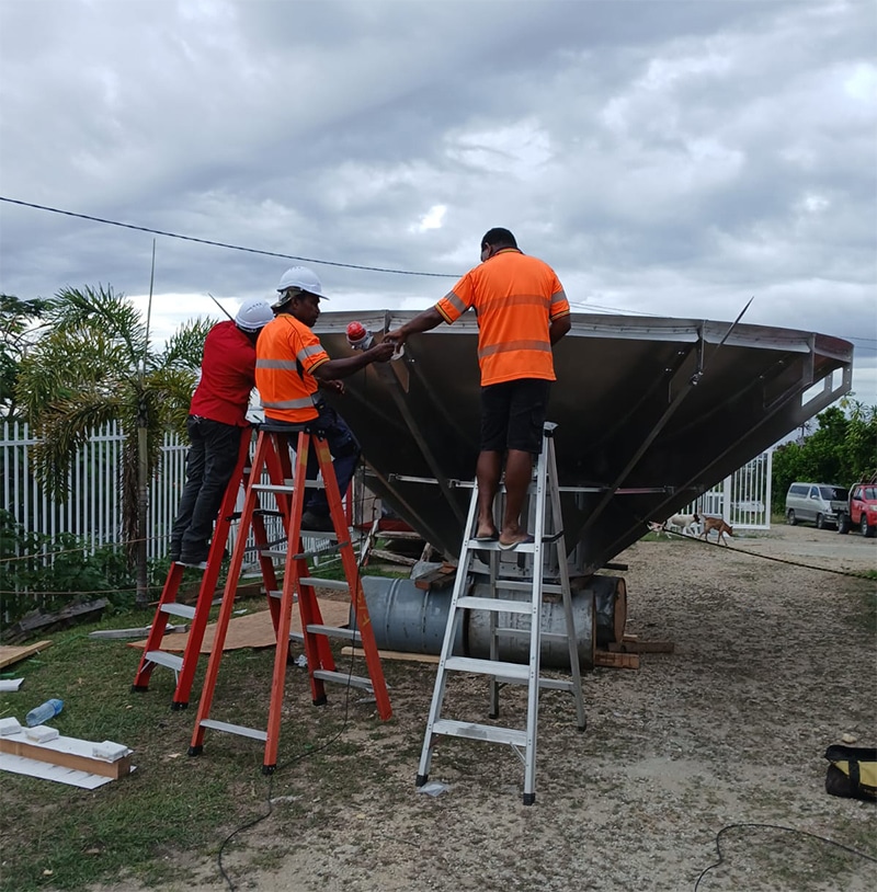Solomon Islands workers installing cellular backhaul equipment