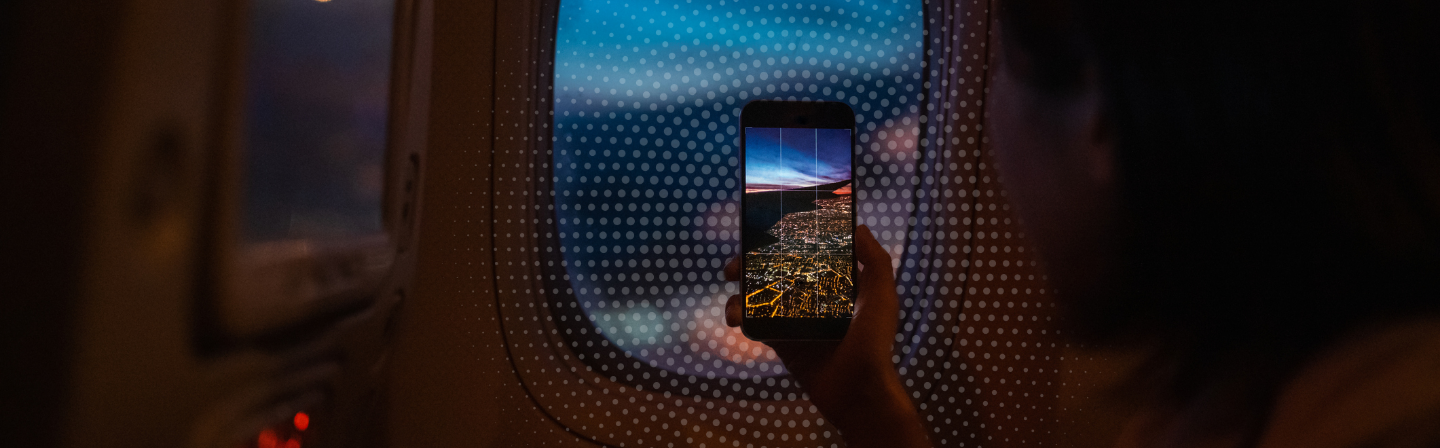 a hand holding a phone with a city on it